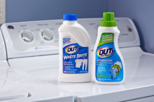OUT Laundry product packages on dryer - ProWash Workwear Odor Eliminator and White Brite Laundry Whitener