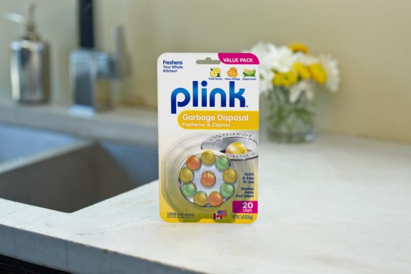 Plink® Garbage Disposal Freshener & Cleaner - Assorted Fragrances package beside kitchen sink