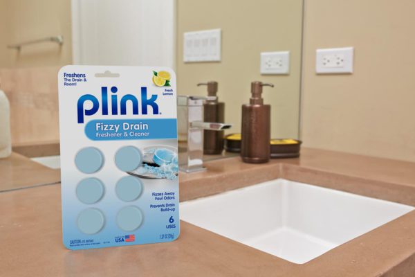 Plink® Fizzy Drain Freshener & Cleaner – Lemon Scent package beside bathroom sink