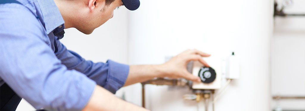 Man adjusting knob on water softener