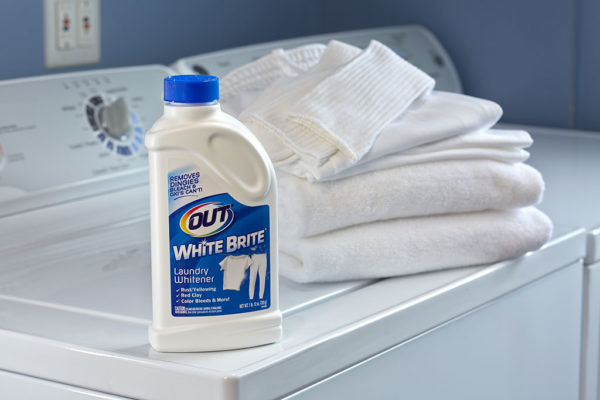 OUT White Brite laundry whitener with folded white laundry on washer