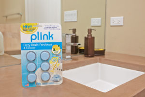Plink Fizzy Drain Freshener package beside bathroom sink